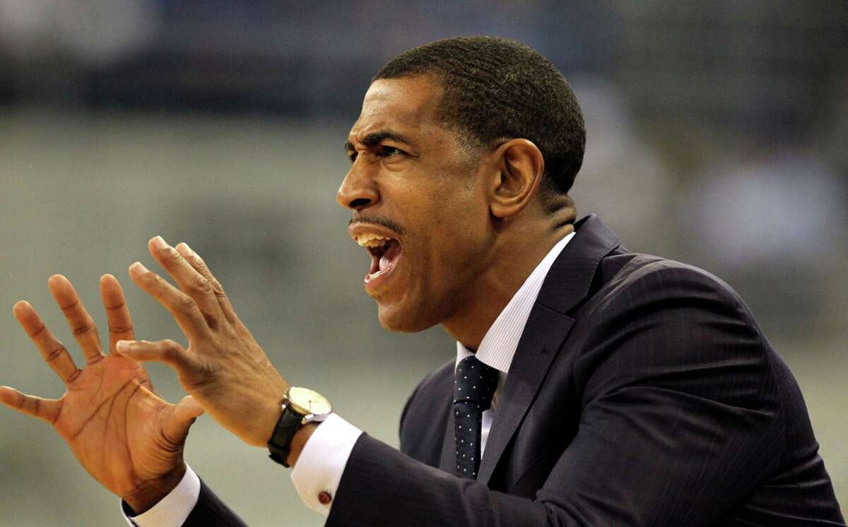 Connecticut coach Kevin Ollie yells to his players during an NCAA college basketball game against Florida, Saturday, Jan. 3, 2015, in Gainesville, Fla. UConn won 63-59. (AP Photo/The Gainesville Sun, Brad McClenny) THE INDEPENDENT FLORIDA ALLIGATOR OUT, MAGS OUT