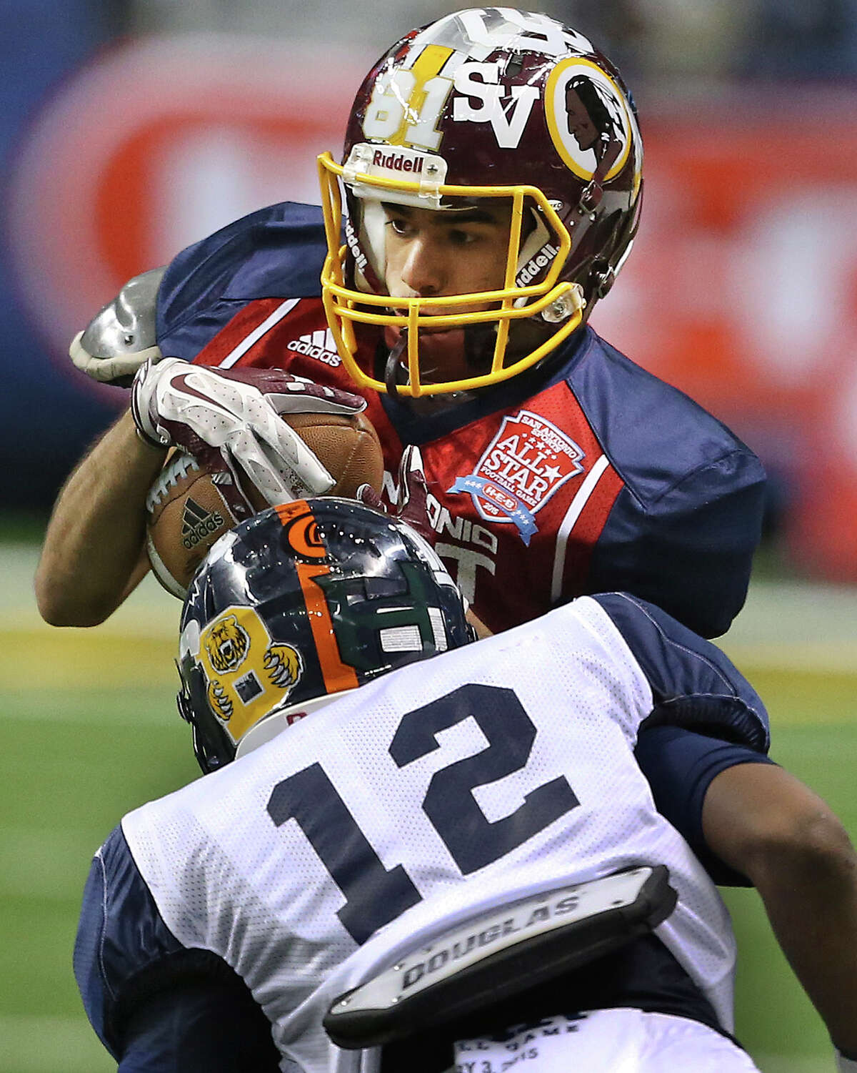 Ian Martinez (Harlandale) rakes in a pass for the East in front of Kadarius Lee (Brandeis) at the San Antonio All Star Game at the Alamodome on December 3, 2015.