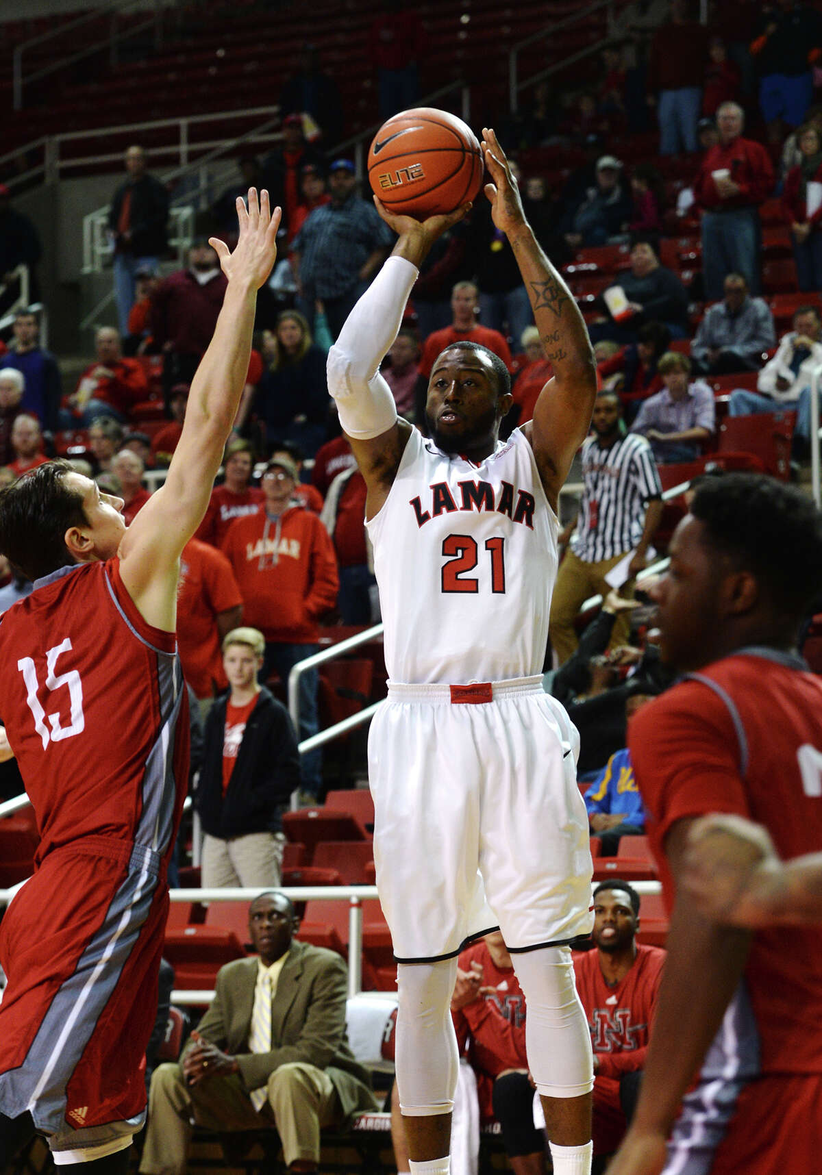 Lamar's Donovan Ross, No. 21, goes up for a shot during Saturday night's game against the Colonels. The Lamar Cardinals hosted the Nicholls Colonels at the Montagne Center on Saturday. Photo taken Saturday 1/3/15 Jake Daniels/The Enterprise
