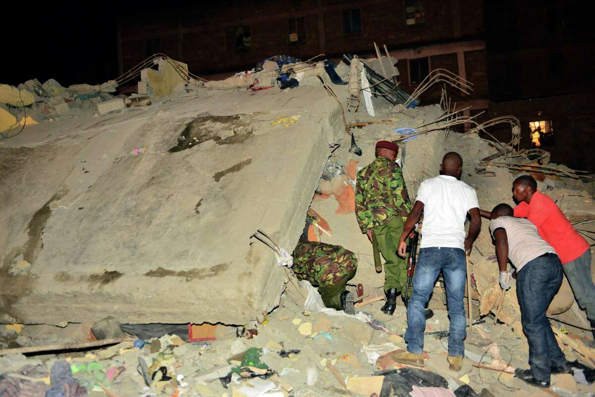 Kenya Para military soldiers and local Kenyans search for survivors of a multi-storey building collapse in the capital Nairobi, Kenya, Sunday, Jan. 4, 2015. The residential building in the Huruma neighborhood of Nairobi collapsed on Sunday and according to the Kenya Red Cross, over a dozen people have so far been rescued but an unknown number are still feared trapped.