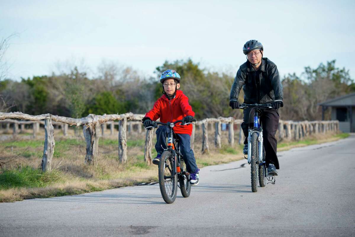 Fengxin Chen, right, and his son Kimmy Chen bike together at Government Canyon State Natural Area in San Antonio, Tx. on Sunday, January 4, 2015. The Chens have been coming to the park for many years and enjoy the natural beauty they said. San Antonio City Council will soon vote on whether or not to annex additional lands in the property mid January.