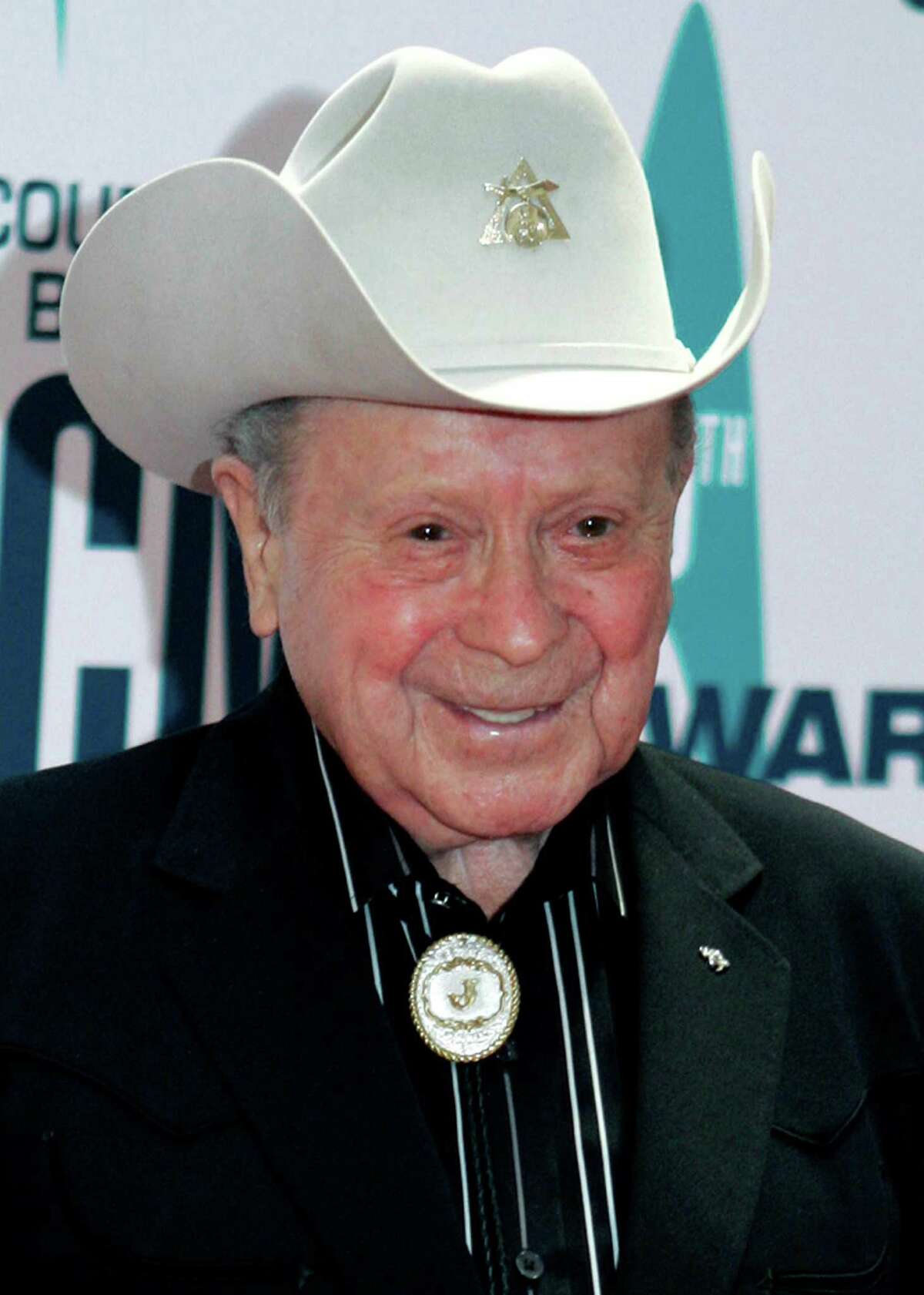 In this Nov. 6, 2006 file photo, Grand Ole Opry star Little Jimmy Dickens arrives at the 40th Annual CMA Awards in Nashville, Tenn. Dickens, a diminutive singer-songwriter who was the oldest cast member of the Grand Ole Opry, has died. Dickens, 94, died Friday, Jan. 2, 2015, at a Nashville-area hospital of cardiac arrest after suffering a stroke on Christmas Day, Opry spokeswoman Jessie Schmidt said.