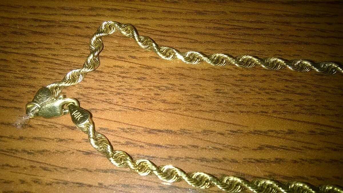 Theresa Green Mireles, a 57-year-old Corpus Christi woman, could see up to two years in prison for allegedly stealing a 14-karat gold necklace (pictured) from the body of Kenneth Grimes during an open wake on Dec. 17 at the Charlie Marshal Funeral Home in Port Aransas. Grimes died Dec. 15 from complications from bone cancer.