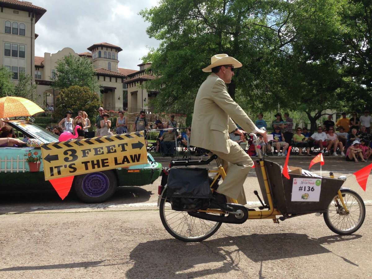 A bicyclist rides in the Houston Art Car Parade on May 10, 2014, to raise awareness of the city's safe passing law, which requires drivers to give cyclists and pedestrians three feet of space.