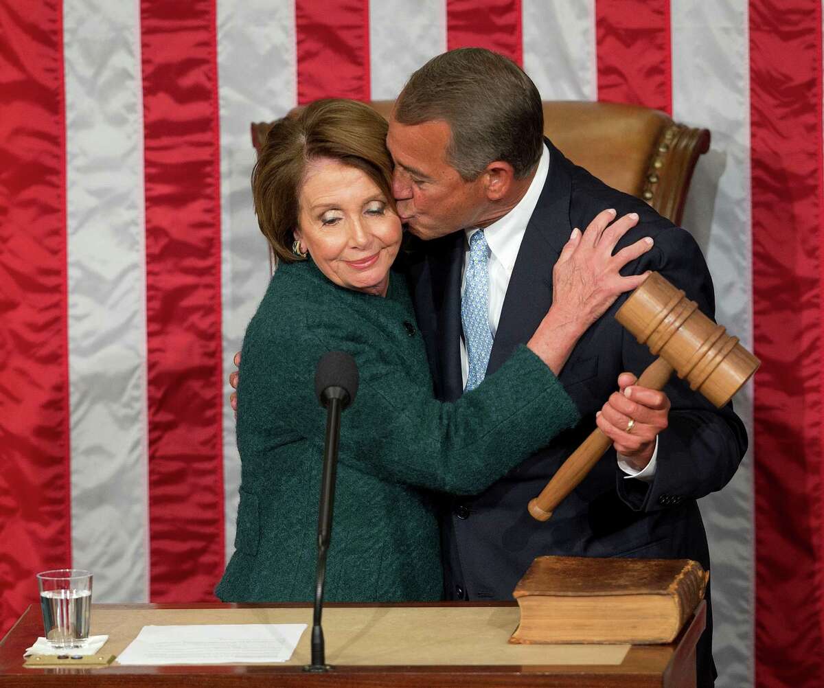House Speaker John Boehner kisses House Minority Leader Nancy Pelosi after he was re-elected to a third term during the opening ﻿of the 114th Congress.