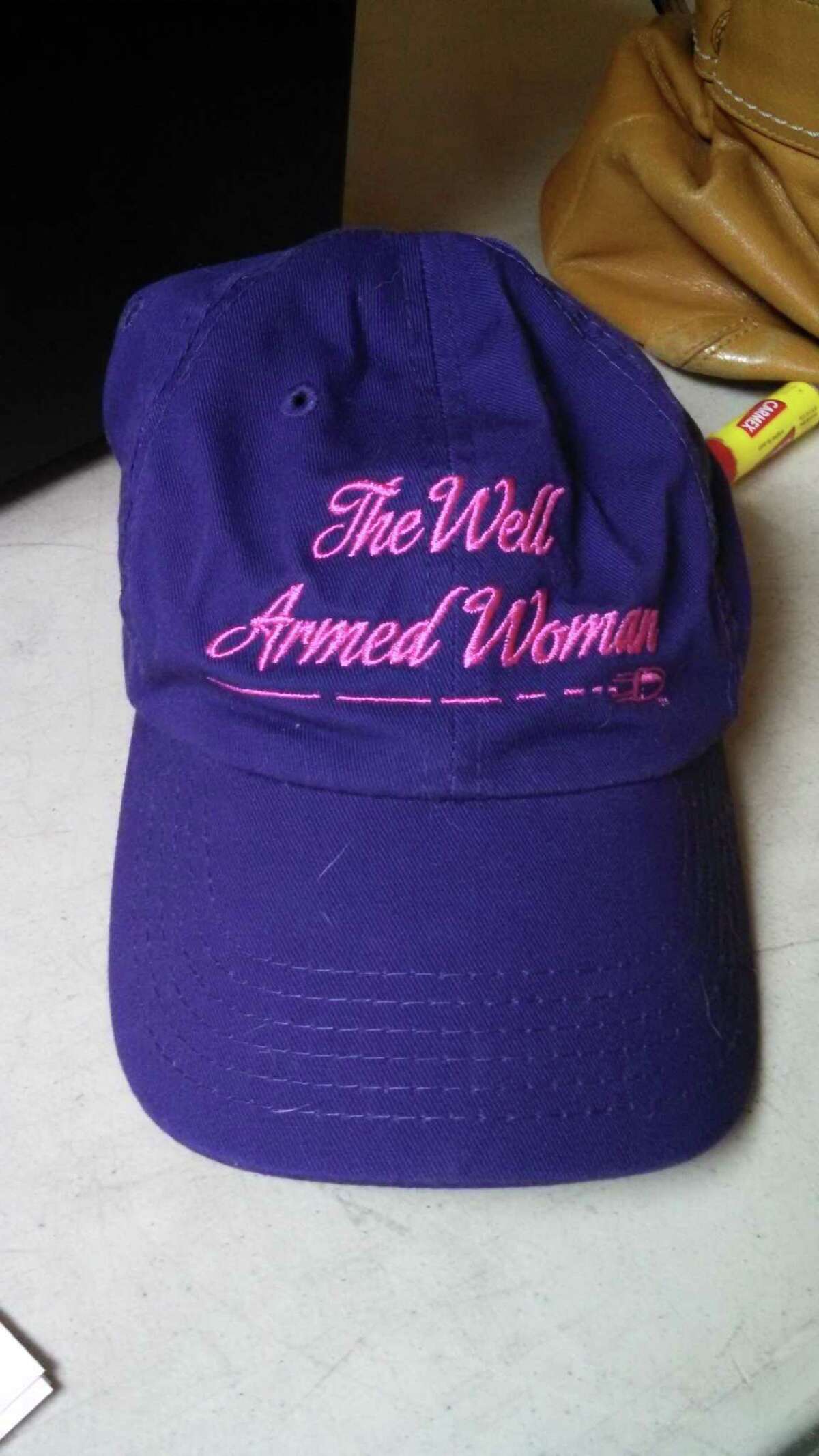 A purple cap with "A Well Armed Woman" embroidered on it on display at the Iroquois Rod and Gun Club. (Leigh Hornbeck/Times Union)
