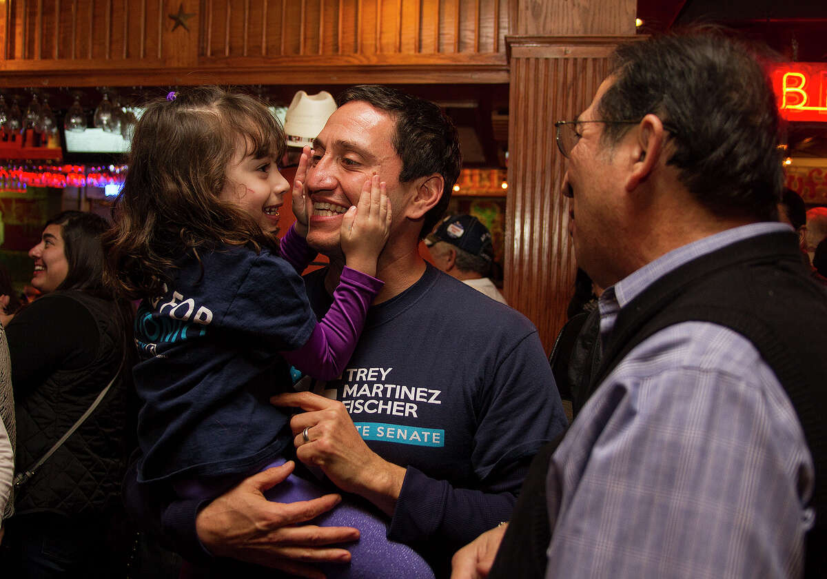State Rep. Trey Martinez Fischer with his daugher Camilla, 4, and Lorenzo Gonzalez (right) waiting on District 26 special election results, Tuesday, Jan. 6, 2015 at Henry's Puffy Tacos.