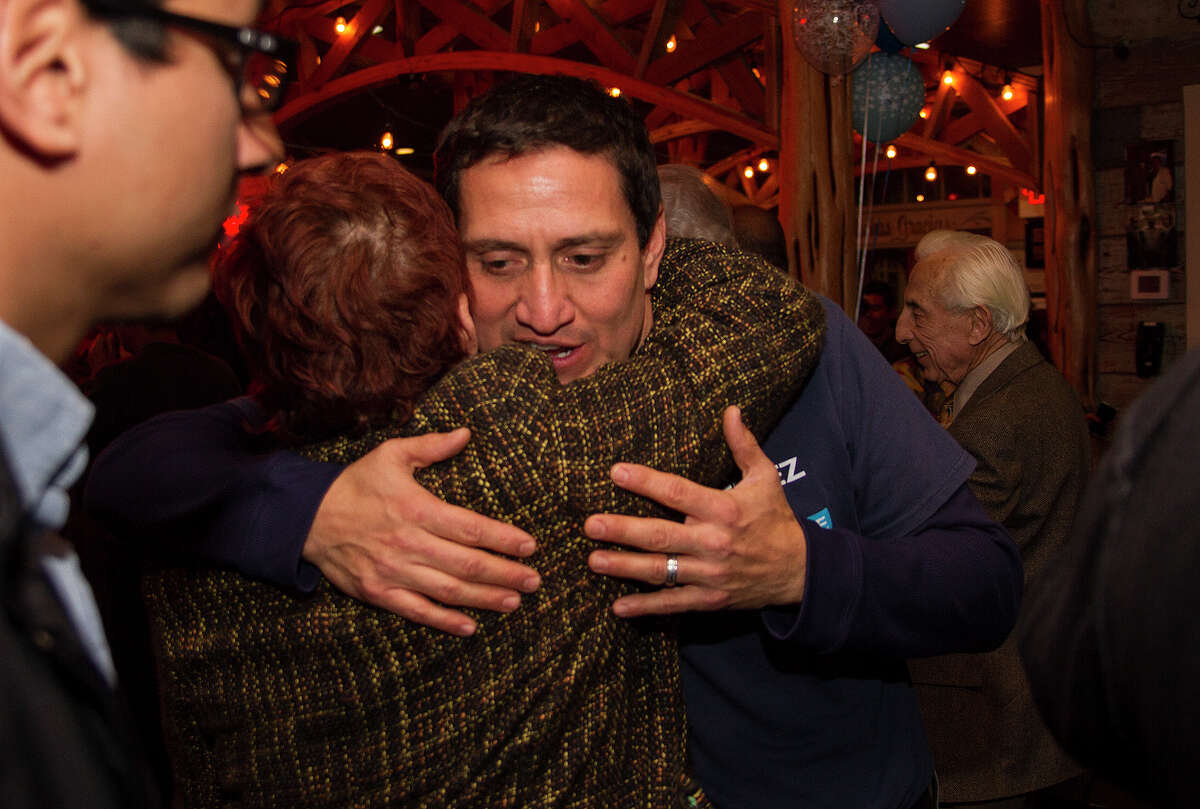 State Rep. Trey Martinez Fischer hugs Qeta LaGrange, Tuesday, Jan. 6, 2015 at Henry's Puffy Tacos as they wait on District 26 special election results.