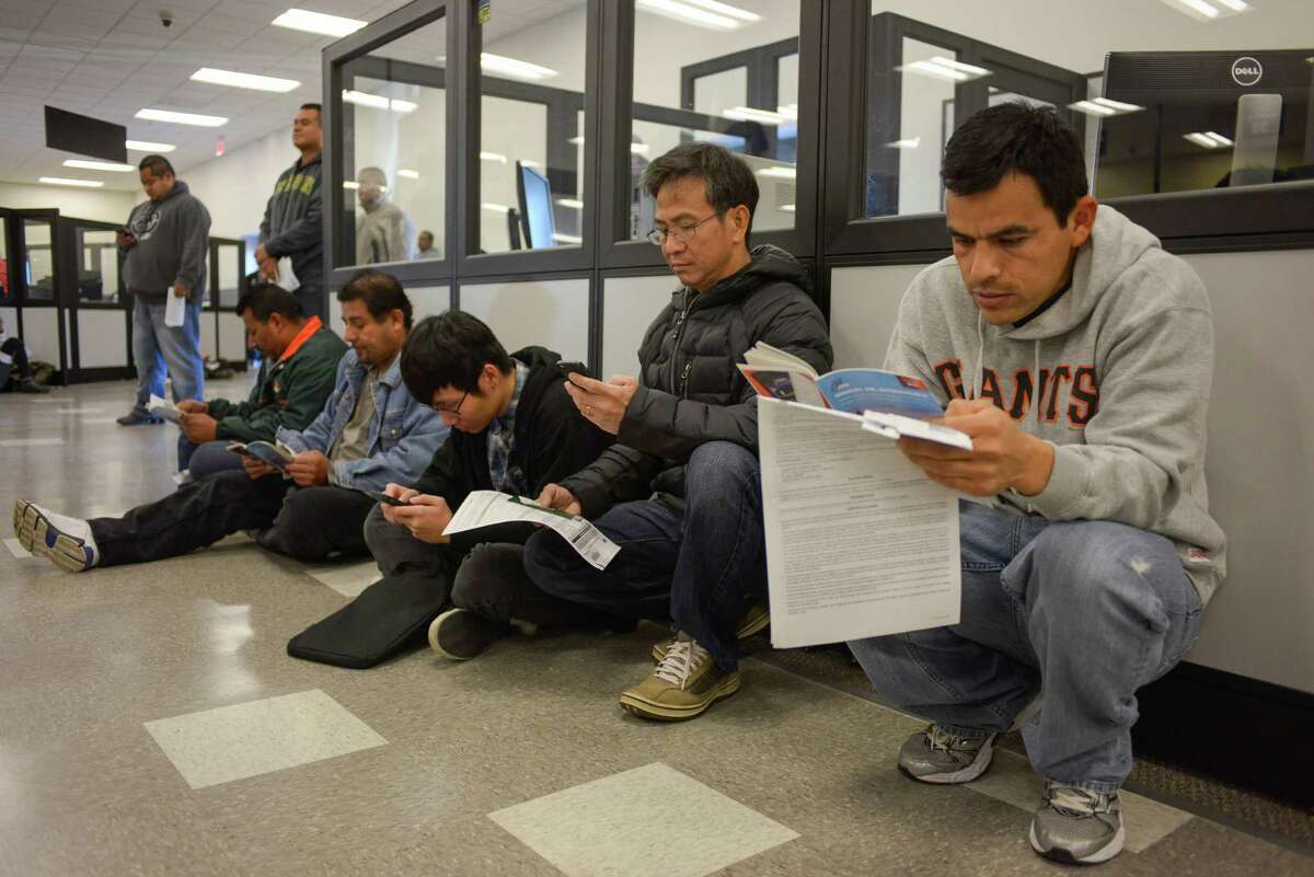 Armando Ramos studies for his drivers test at the DMV on Friday, January 2, 2014 in San Jose, Calif. The DMV is allowing undocumented immigrants to obtain driver's licenses under AB 60.