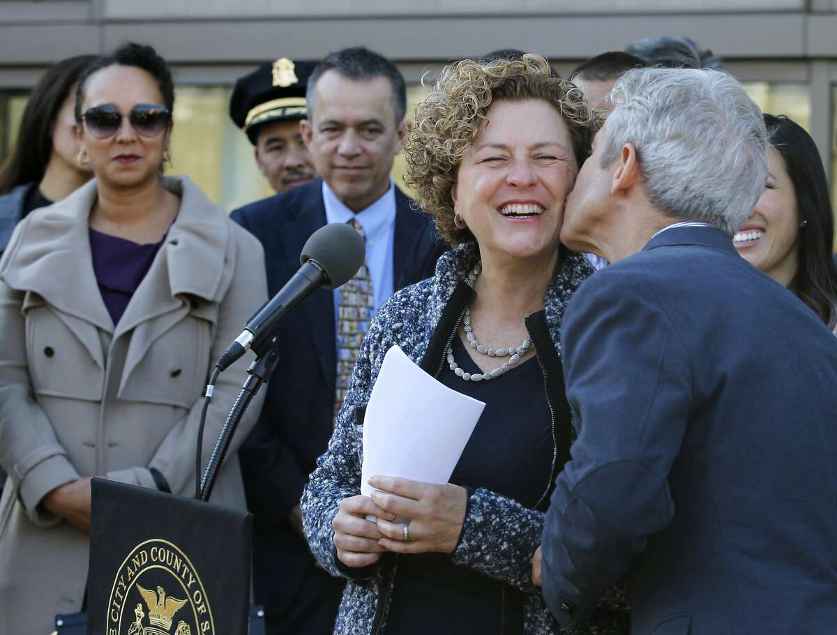Julie Christensen gets a kiss from her husband Greg Smith after she was appointed by Mayor Ed Lee to fill the vacant District 3 seat on the Board of Supervisors in San Francisco, Calif. on Wednesday, Jan 7, 2015. Christensen takes over from David Chiu, who was elected to the state assembly in November.