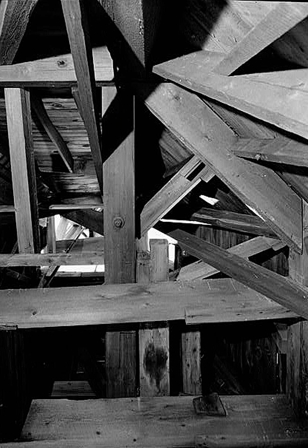 Looking up into the interior of the Bronson Windmill reveals a maze of wooden supports. The windmill pumped water from an underground water tank and cistern at the bottom of the windmill. Courtesy: Library of Congress.