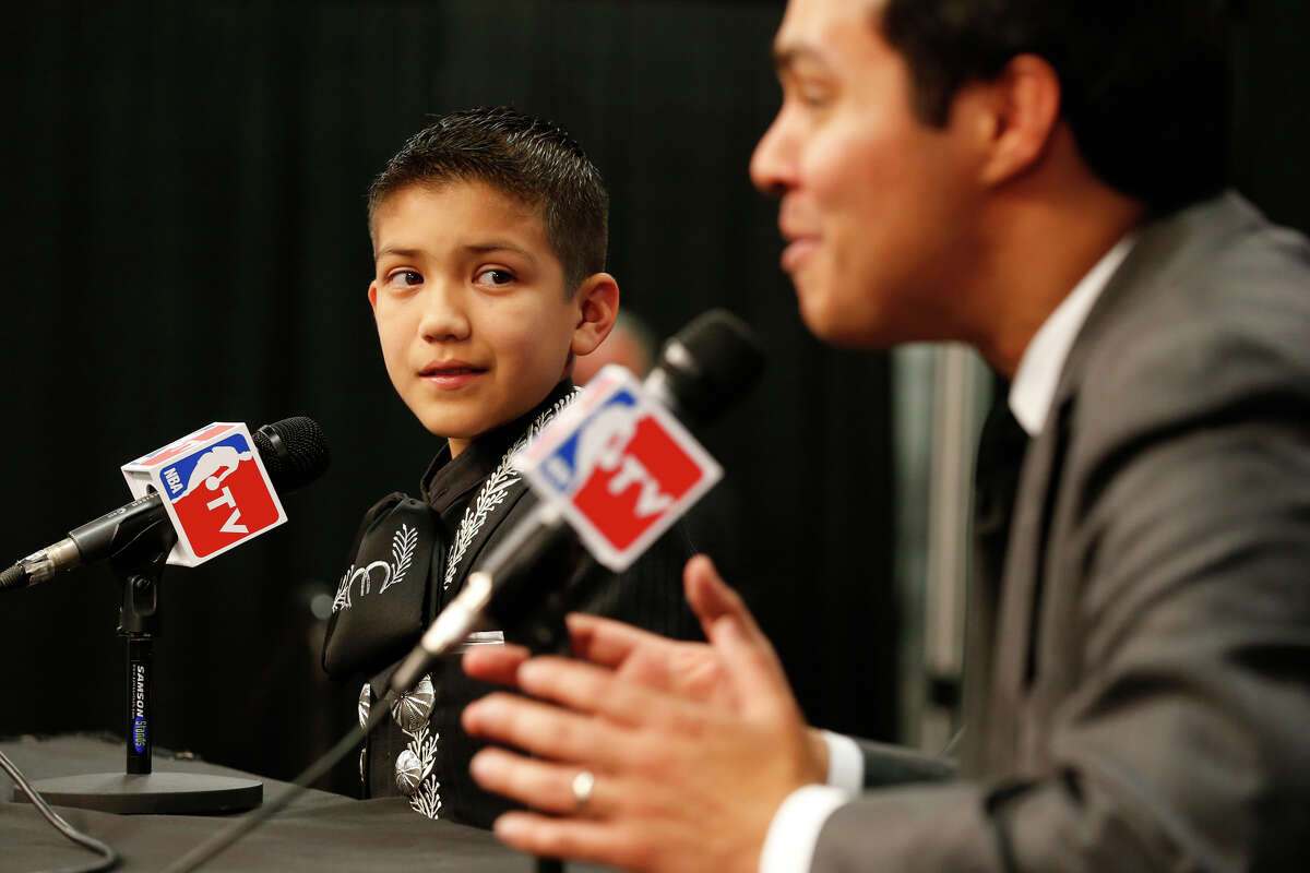 In 2013, Sebastian De La Cruz was seated next to San Antonio Mayor Julian Castro before the start of Game 4 of the 2013 NBA Finals Thursday June 13, 2013 at the AT&T Center.