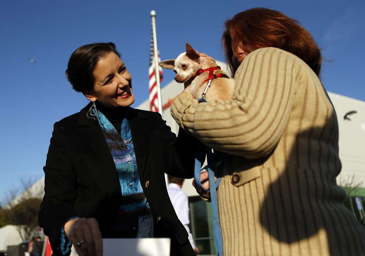 Oakland Mayor Libby Schaaf visits with Allison Lindquist, CEO East Bay SPCA, and "Minnie Mouse" at Pet Food Express corporate headquarters in Oakland, Calif. on Wednesday, January 7, 2015.