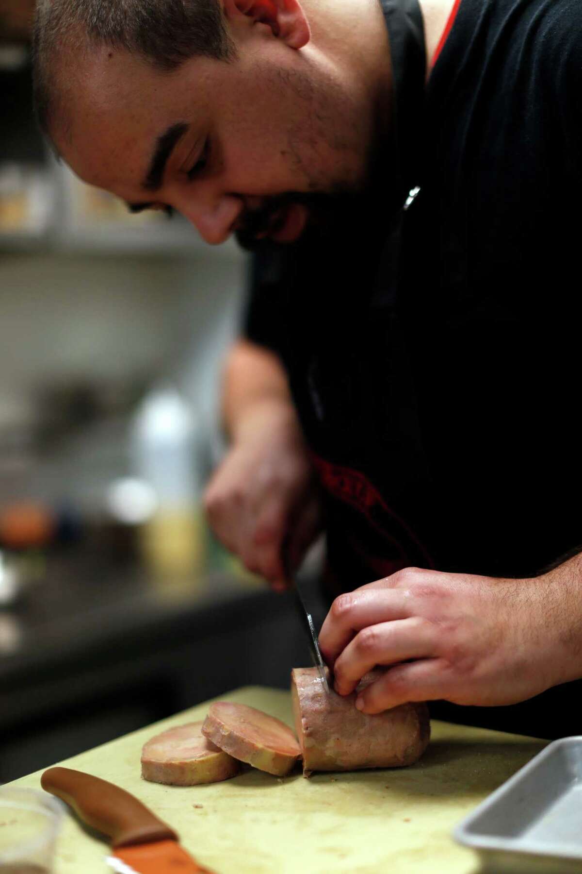 Manny Castrillo slices foie gras at Dirty Habit in San Francisco on Wednesday.