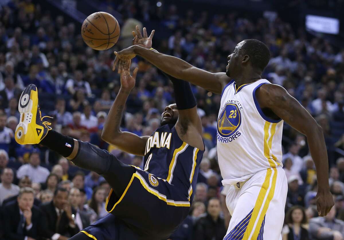 Golden State Warriors' Draymond Green, right, blocks the shot of Indiana Pacers' C.J. Miles during the first half of an NBA basketball game Wednesday, Jan. 7, 2015, in Oakland, Calif. (AP Photo/Ben Margot)