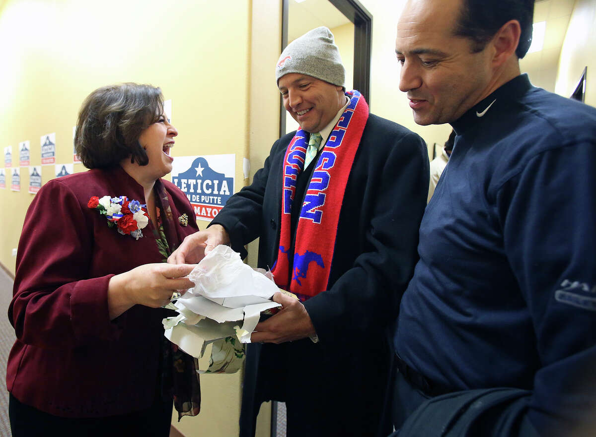 Leticia Van de Putte offers a gift of a Thomas Jefferson tie to former mayor Ed Garza, a fellow Jefferson High School graduate, as she kicks off her run for mayor at her campaign headquarters at 1800 W Commerce on January 8, 2015. Jose Menendez watches the greeting.