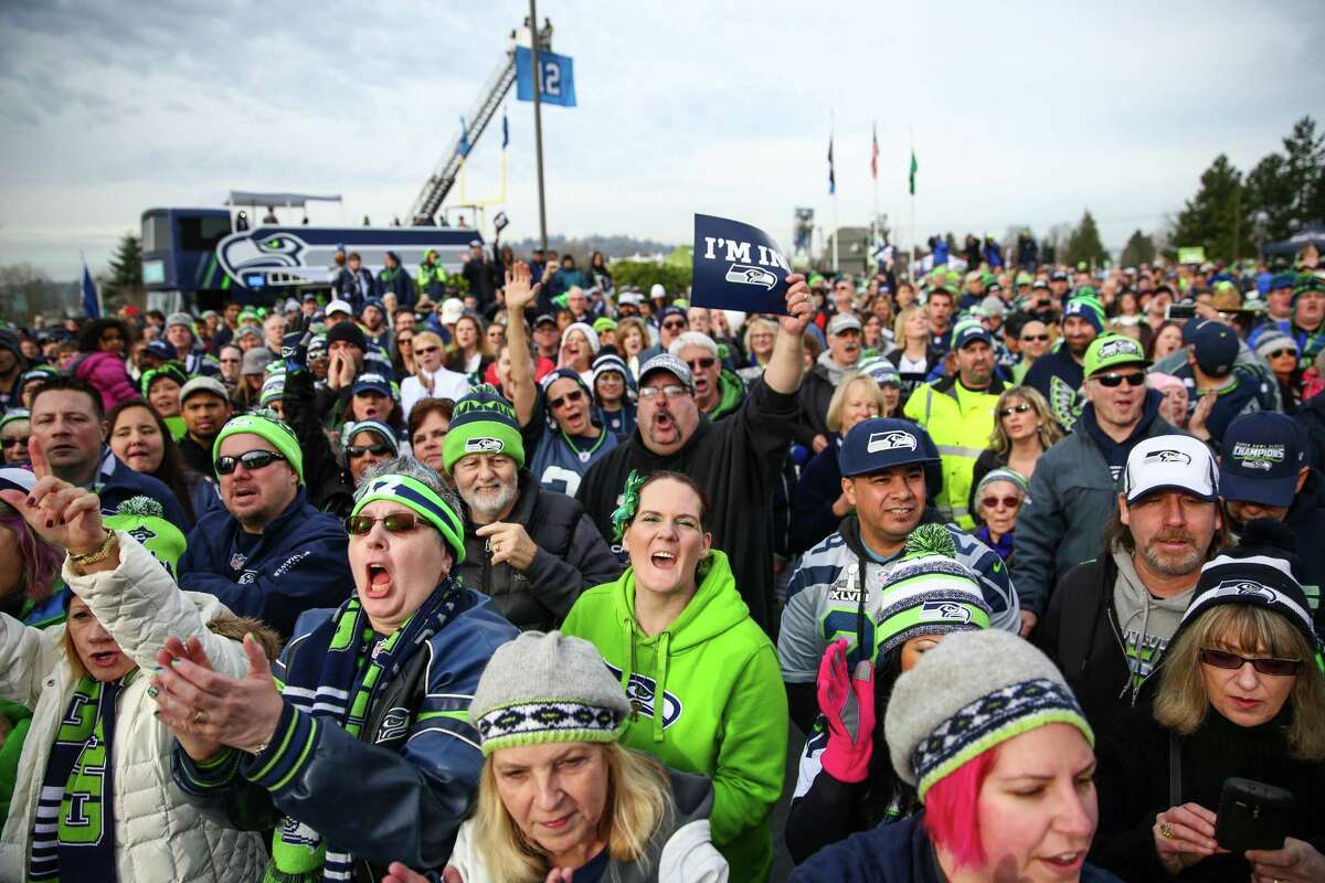 People gather during a Seattle Seahawks fan rally at Renton City Hall on Friday, January 9, 2015. Hundreds of Seahawks fans came to the rally to show support for the Hawks before their playoff matchup with the Carolina Panthers.