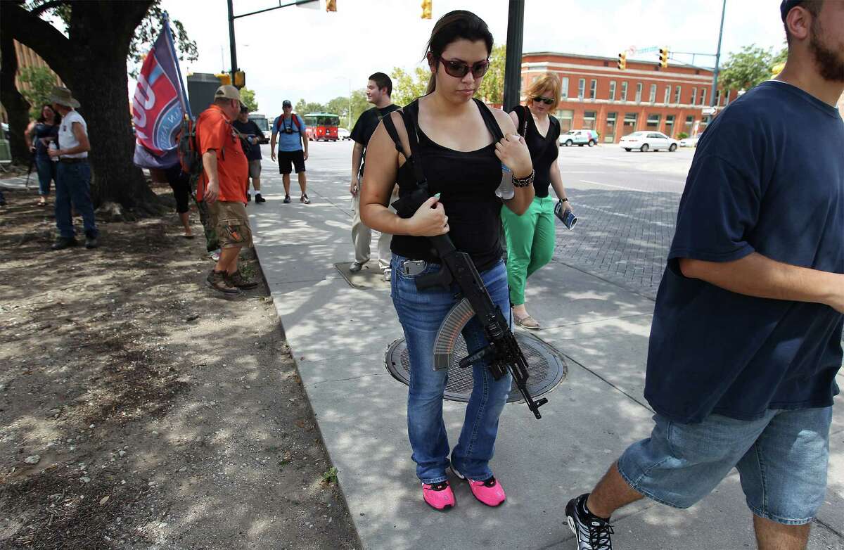 Alex Serna of Houston joins other women carrying assault rifles at an Open Carry Texas event in September. The event was called "Goddesses With Guns" and was held to raise awareness that men are not the the only ones interested in gun rights.