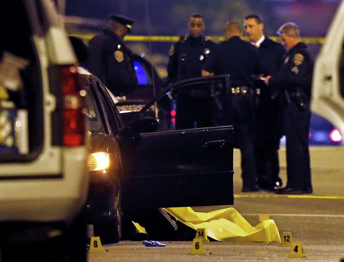 Police work at the scene of a quadruple homicide on Laguna Street near Page Street in San Francisco on Friday.