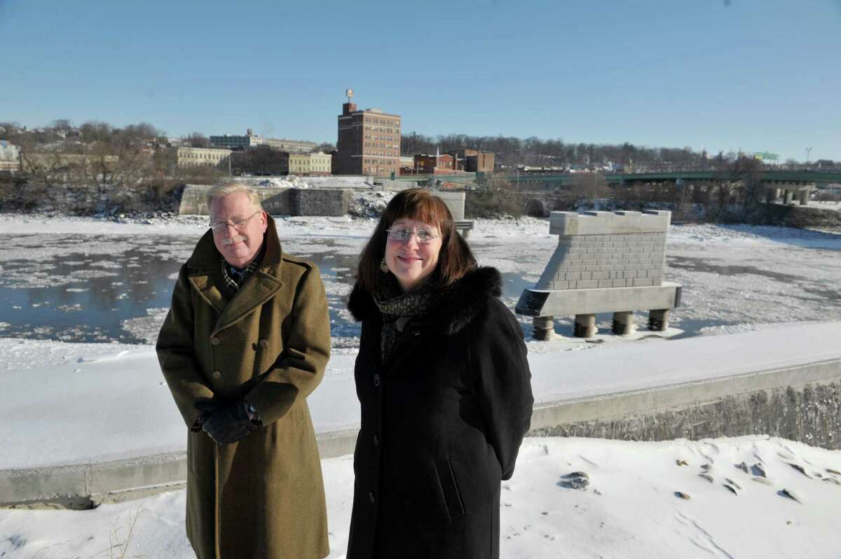 Robert von Hasseln, left, director of Community and Economic Development for Amsterdam and Amsterdam Mayor Ann Thane pose at the construction site where the Mohawk Valley Gateway Overlook bridge will be built Thursday, Jan. 8, 2015, in Amsterdam, N.Y. The supports for the bridge are seen in the river in the background. (Paul Buckowski / Times Union)
