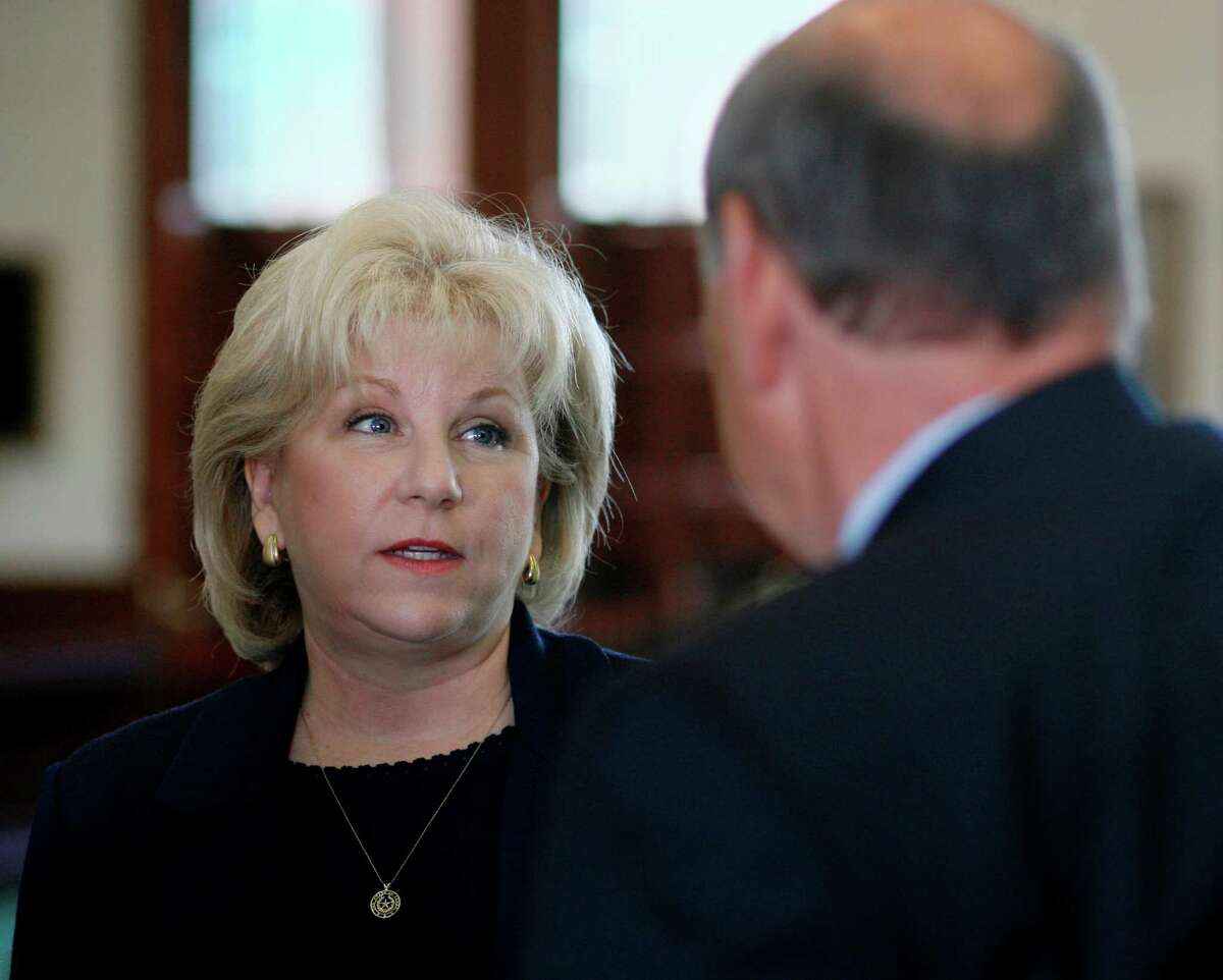 Sen. Jane Nelson, R-Lewisville, left, talks with Carey Cockerell, commissioner of the Texas Department of Family and Protective Services, before he testified to members of her Senate Committee on Health and Human Services Wednesday, April 30, 2008, in Austin, Texas. Mr. Cockerell oversees the state agency now caring for the children who are in state custody after the raid of a polygamist sect earlier this month. He said medical examinations have revealed numerous physical injuries. Sen. Nelson chairs the committee. (AP Photo/Harry Cabluck)