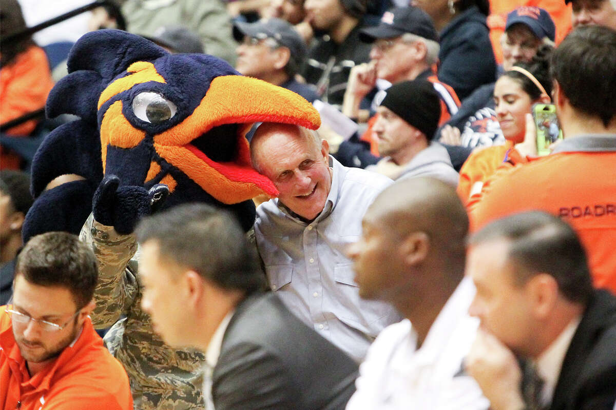 Rowdy the Roadrunner plays with football coach Larry Coker as they pose for a photo in the stands during the second half UTSA’s basketball game with Louisiana Tech at the UTSA Convocation Center on Jan. 10, 2015.