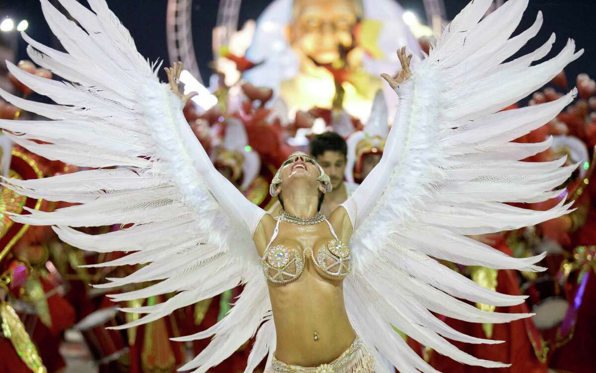 A dancer with the Ara Yevi samba school performs during a carnival parade that pays tribute to Pope Francis in Gualeguaychu, Argentina, early Sunday, Jan. 11, 2015. The troupe's main song says : "We're the power of a revolution, let's make noise, it's carnival," quoting the Argentine Pontiff's famous call to "make noise" to the crowd during his 2013 visit to Brazil.