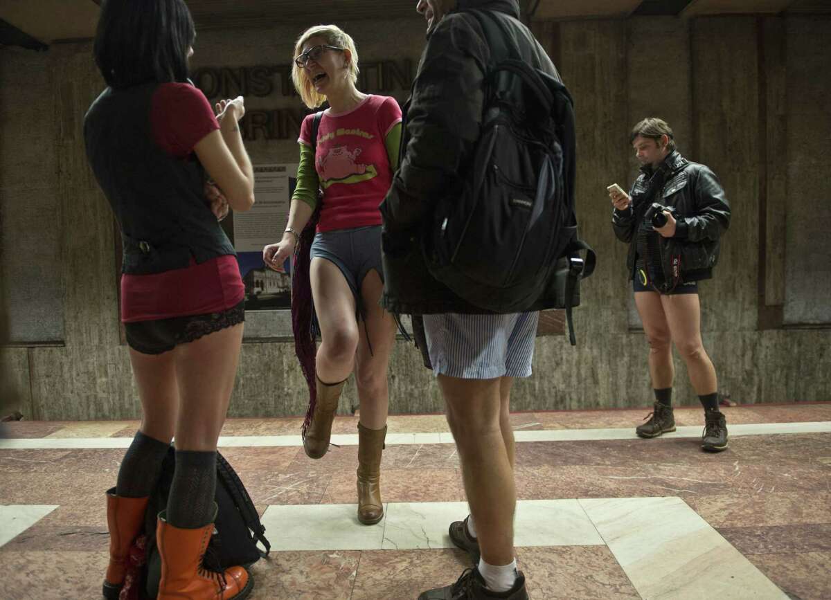 Young people, stripped to their underpants, wait for the subway as they take part in Romania's first edition of the "No pants subway ride day" organized in Bucharest January 11, 2015. The No Pants Subway Ride is an annual event staged across major cities of the World every January. The mission started as a small prank with seven guys and has grown into an international celebration of silliness, with dozens of cities around the world participating each year. AFP PHOTO / DANIEL MIHAILESCU