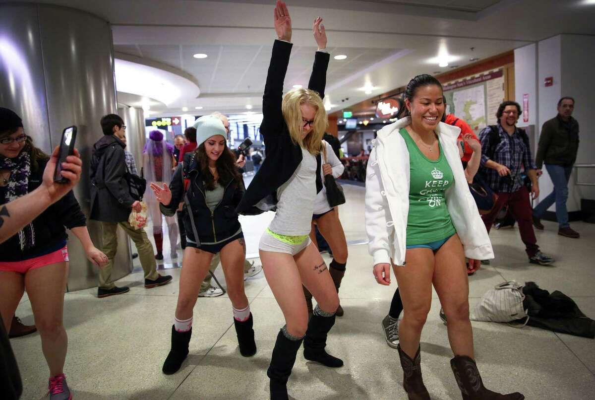 Participants have a no pants dance off at SeattleÐTacoma International Airport during Seattle's 6th annual No Pants Light Rail Ride. During the quirky annual event, participants strip down to their underwear and ride the rail as if nothing is unusual. They also make stops along the route, often surprising people. Photographed on Sunday, January 11, 2015 in Seattle.