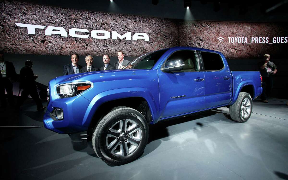 Toyota executives stand with the new Tacoma midsize pickup truck after it was revealed to the media in Detroit. More than 5,000 journalists from around the word will see about 45 new vehicles.