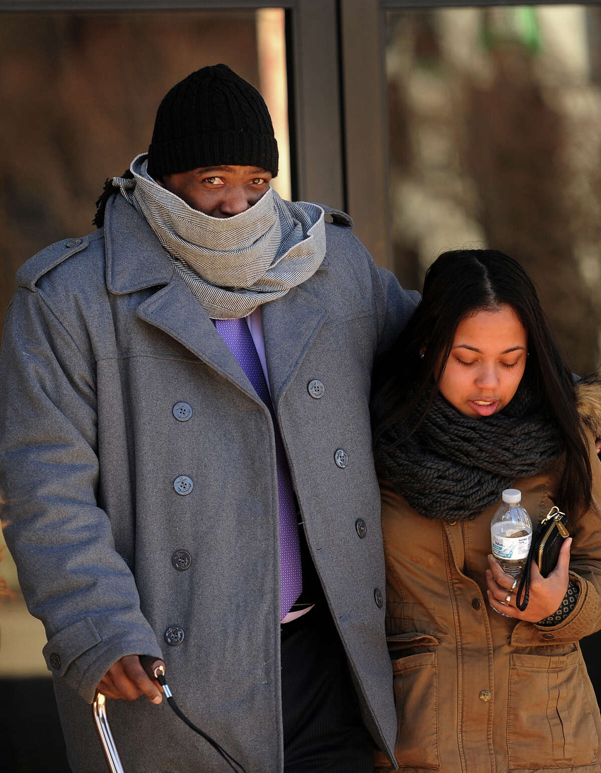 Bridgeport Police Officer Clive Higgins walks with his arm around his daughter as he exits Federal Court in Bridgeport, Conn. on Tuesday, January 13, 2015 where he is standing trial for the 2011 beating of Orlando Lopez Soto. Higgins was videotaped with two others officers kicking Lopez Soto on the ground following a car chase. The other officers, Elson Morales and Joseph Lawlor, pleaded guilty in June.