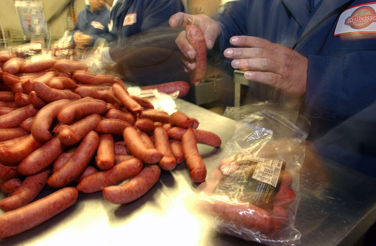 Workers at Kiolbassa Provision Co. work speedily to package their sausage product at the near West Side plant. JOHN DAVENPORT / STAFF