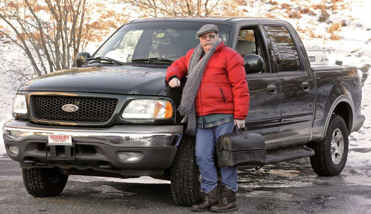 Veterinarian Paul Elwell stands with the truck he uses to make house calls. Elwell has had a practice in Roxbury for 30 year and has sold it as of the end of last year. He is still working a few days a week at the practice. Tuesday, January 13, 2015, in Roxbury, Conn.