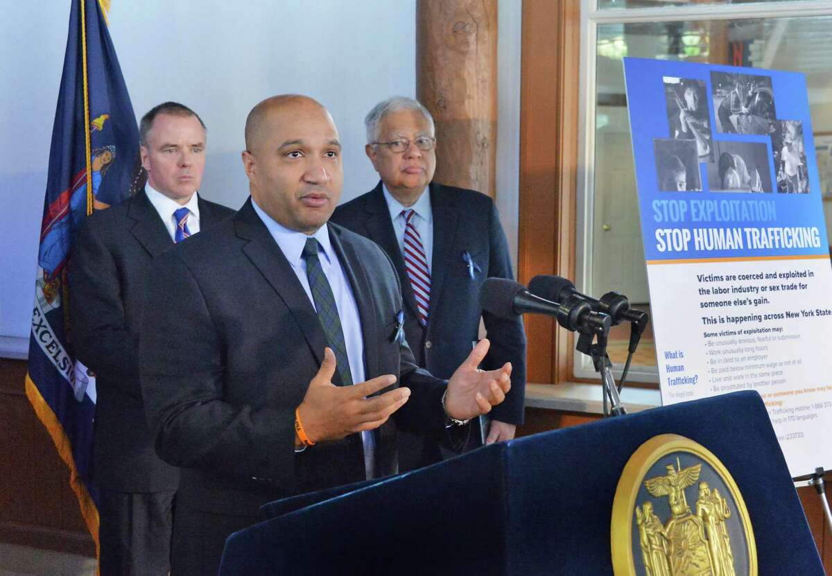 Albany County District Attorney David Soares is joined by Michael C. Green, state Division of Criminal Justice Services executive deputy commissioner, left, and state Secretary of State Cesar Perales, right, during a news conference to debut a poster to raise public awareness and bring attention to the scourge of human trafficking in New York on Tuesday Jan. 13, 2015, in Schenectady, NY. (John Carl D'Annibale / Times Union)