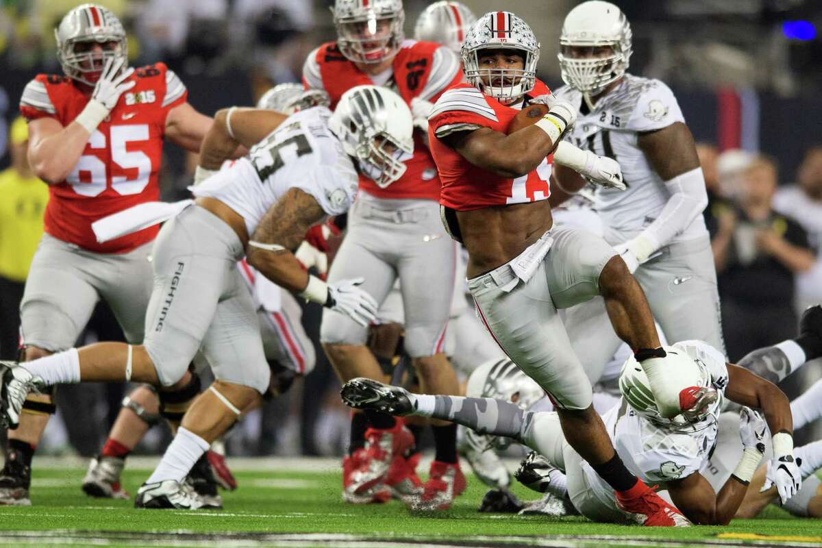 Ohio State running back Ezekiel Elliott breaks away on a 33-yard run for a touchdown, one of four for him in the game, during the first quarter of their championship victory over Oregon at AT&T Stadium in Arlington.