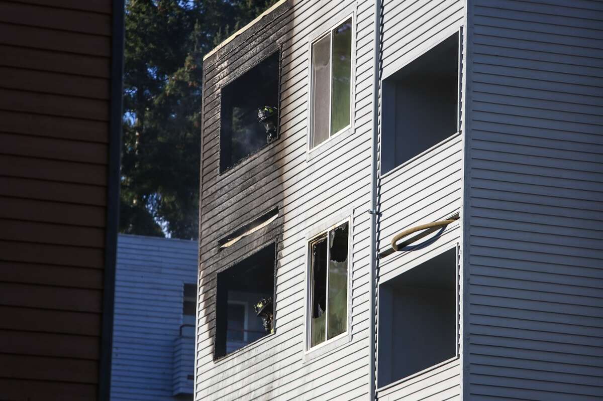 Seattle firefighters found flames coming from two stories of a four-story condo building in Northgate Tuesday afternoon. Crews knocked down the flames and no one was injured.