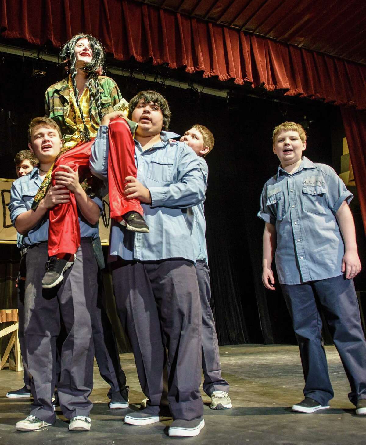Kaylie Law, 15, portrays "Bloody Mary" as she rides the shoulders of Nick Rodriguez, 17, left, and Fernando Escalera, 15, as Christopher Morris, 15 and Grant Geiman, 14 sing along during rehearsal for "South Pacific."