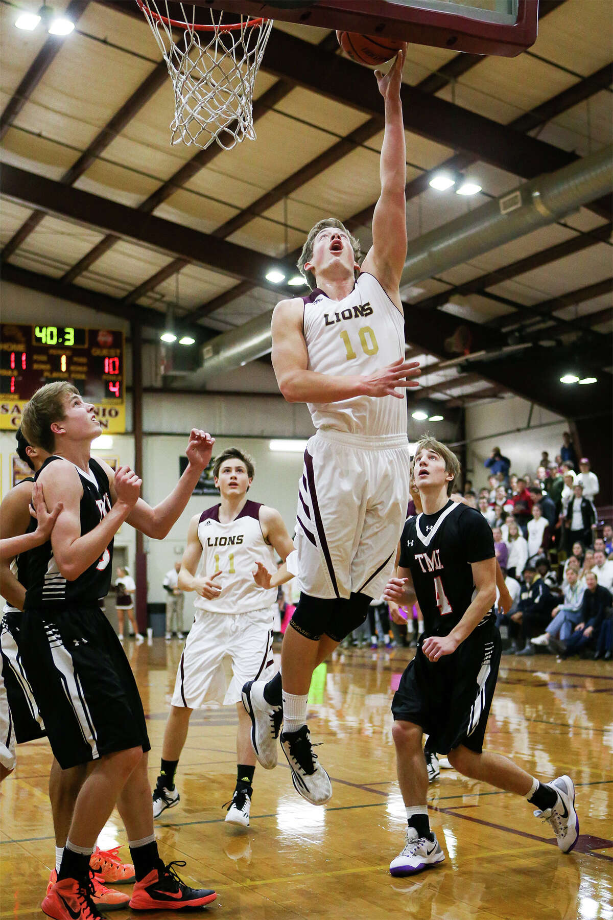 San Antonio Christian's Andrew Hawking (10) goes to the basket during the first half.