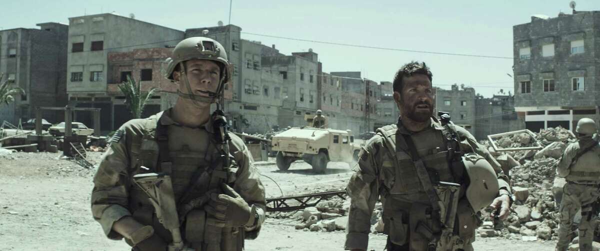 Jake McDorman, left, and Bradley Cooper in "American Sniper," which was shy of a Super Bowl Sunday record.﻿