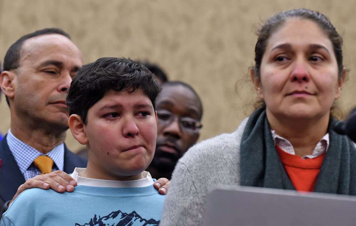 Rep. Luis V. Gutierrez, D-Ill., supports Adolofo Martinez, 13, while his mother, Isabel Aguilar, addresses a news conference on Capitol Hill about immigration. Isabel Aguilar, right, speaks during a news conference on Capitol Hill in Washington, Wednesday, Jan. 14, 2015, on the House Republican's immigration policies. Republicans in the House of Representatives voted Wednesday to overturn President Barack Obama’s immigration policies and remove protections for immigrants brought illegally to America as kids. Aguilar's son Adolofo Martinez, 13, center, and Rep. Luis V. Gutierrez, D-Ill. listen at left. (AP Photo/Susan Walsh)
