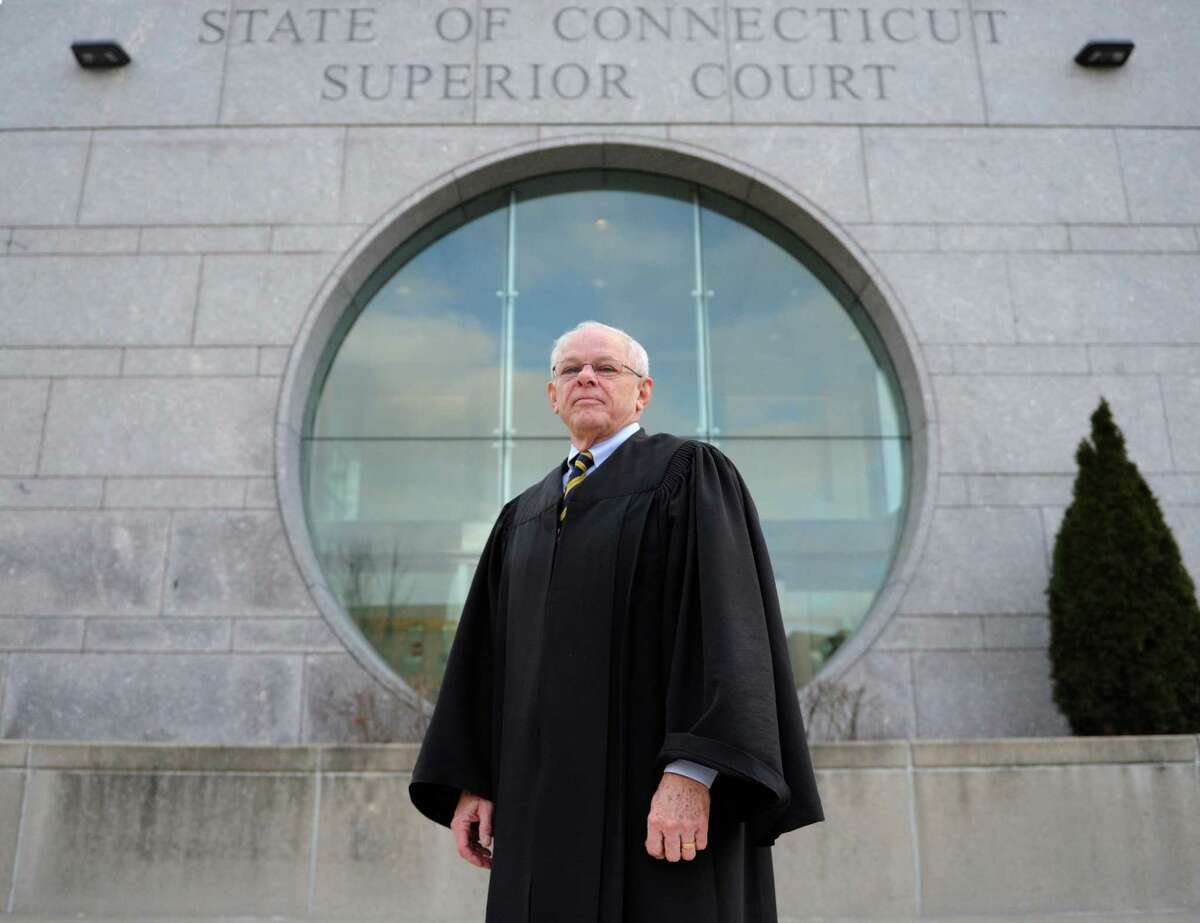 The Hon. Richard Comerford poses outside the State of Connecticut Superior Court in Stamford, Conn. Wednesday, Jan. 14, 2015. Judge Comerford, who has been on the bench in Stamford for many years, has turned 70 and will soon become a judge trial referee.
