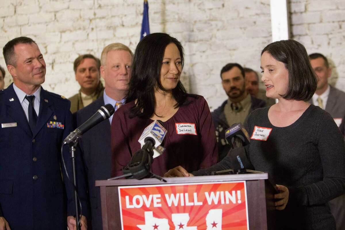 Victor Holmes and Mark Phariss stand alongside Cleopatra de Leon and Nicole Dimetman at an event in New Orleans on Jan. 8 celebrating their cases being heard at the 5th Circuit U.S. Court of Appeals. The couples have been active in fighting Texas' ban on same sex marriage.