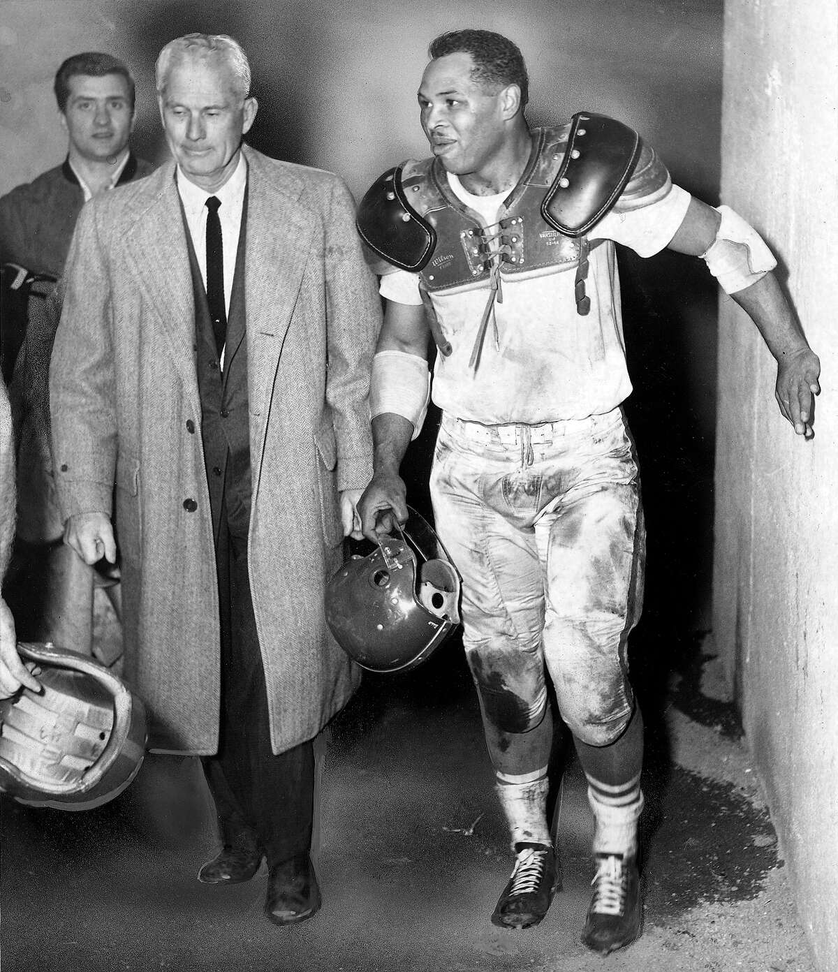 Lawrence "Buck" Shaw , seen here with Joe Perry, in 1954 was head coach of the 49ers from 1946 to 1954 and left the team with a 71-39-04 record. Shaw was the San Francisco 49ers' first head coach, his first NFL coaching job after leading Santa Clara University to two Sugar Bowl wins and coaching at Cal for a year.