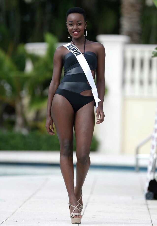 Miss Universe contestant Gaylyne Ayugi, of Kenya, walks along the pool duri...