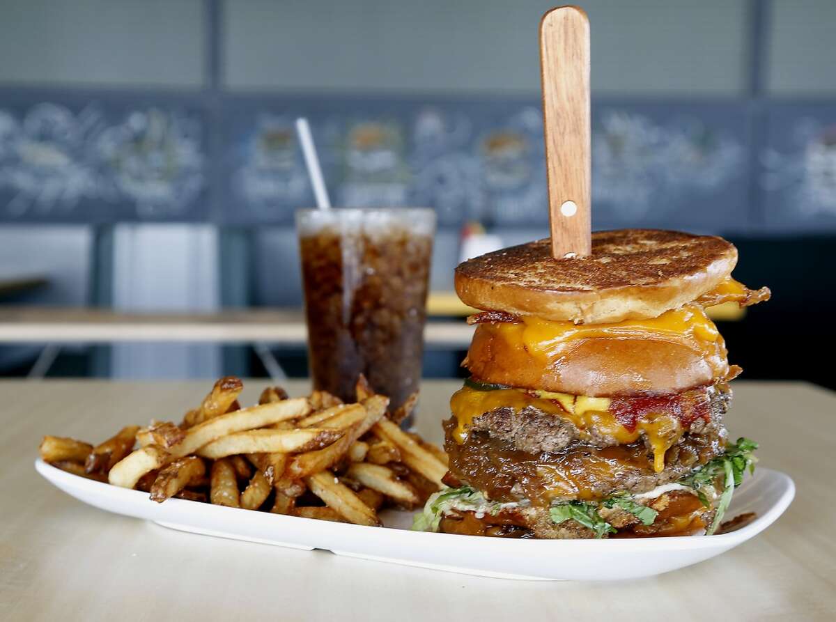 The Detention burger with two applewood smoked bacon grill cheeses used as a bun for two beef patties, each topped with cheddar, onions at Bernie's Burger Bus restaurant. Bernie's will participate in a special pop-up at the Burger Joint on June 28.