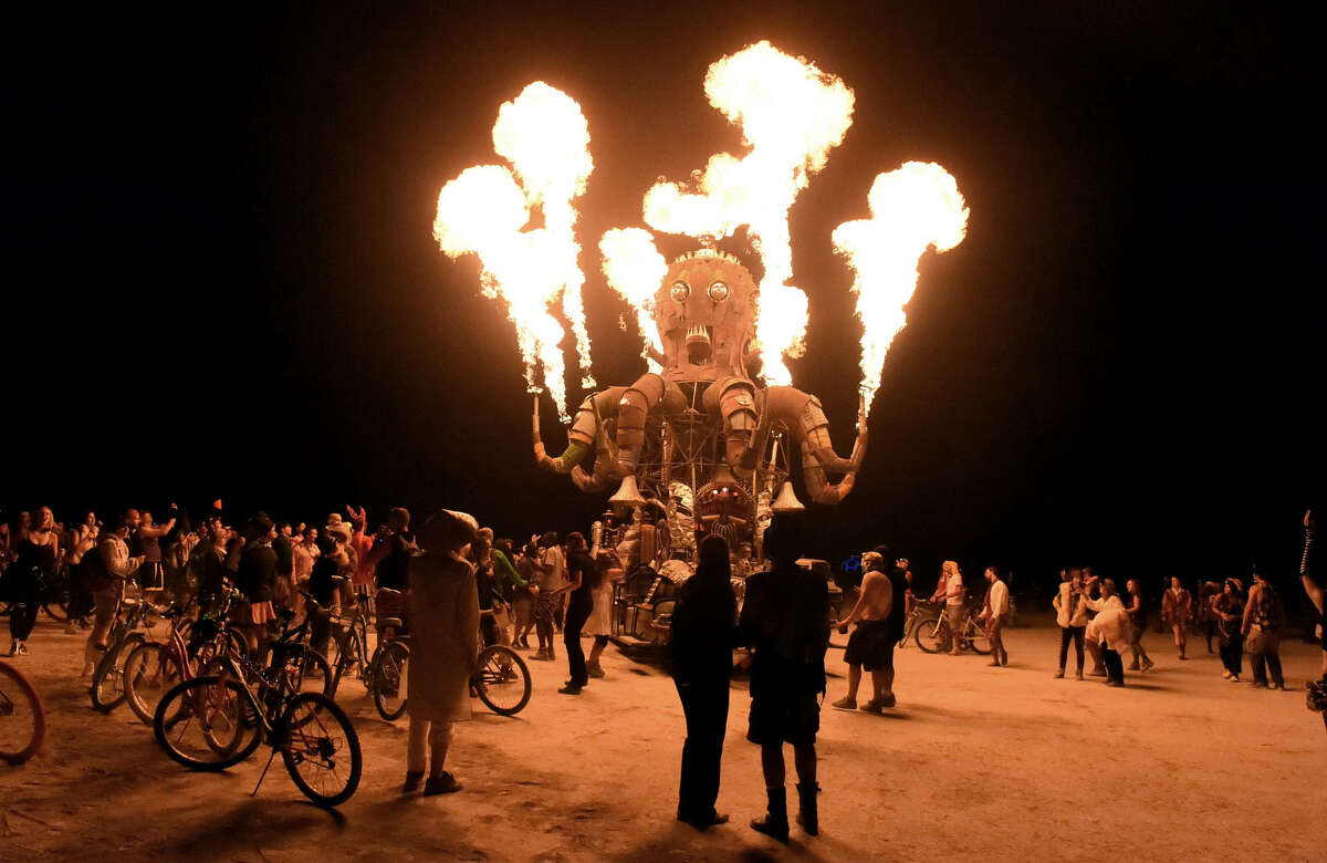 Burners enjoy the 2014 Burning Man festival with its drum circles, decorated art cars, guerrilla theatrics and colorful theme camps.