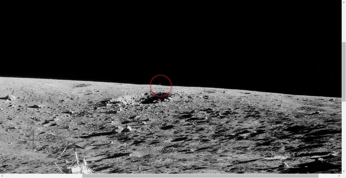 SLIDE 1 Zoomed: The UFO watchers at UFO Sightings Daily speculate that a moving blur in the background of these NASA Apollo 12 images is an alien drone keeping an eye on the space agency crew as it works. See as the spot appears to move in these images.