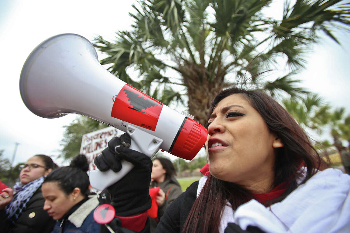 Julieta Paredes, with the LUPE organization takes the megaphone early Thursday morning during a protest outside the federal courthouse in Brownsville, Texas. Attorneys for 25 states are going before a federal judgein Brownsville Thursday to argue for a rollback of President Barack Obama's expansive executive actions to spare nearly 5 million people living in the U.S. illegally from deportation. (AP Photo/The Brownsville Herald, Yvette Vela)