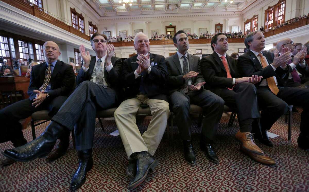 Texas Lt. Gov.-elect Dan Patrick, second from left, Agriculture Commissioner Sid Miller, Land Commissioner George P. Bush, Comptroller Glenn Hagar and Attorney General Ken Paxton applaud Gov. Rick Perry during his farewell address to a joint session of the Texas Legislature, Thursday, Jan. 15, 2015, in Austin, Texas. (AP Photo/Eric Gay)