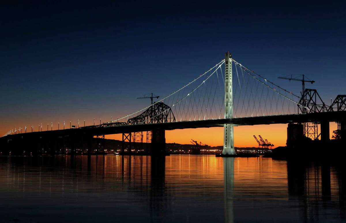 The new eastern span of the Bay Bridge is illuminated at daybreak on Dec. 23.